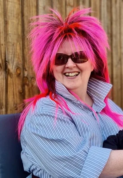 Ethna at an 80s fancy dress party, wearing a dramatic pink wig
