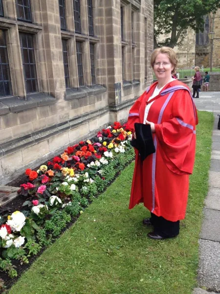 Ethna in doctoral robes at her PhD graduation ceremony